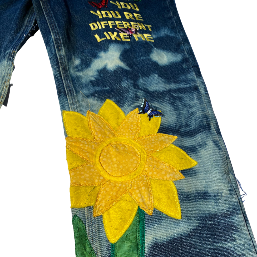 Dark blue Unapologetic Youth jeans with classic five-pocket design and straight-leg fit, shown on a model.