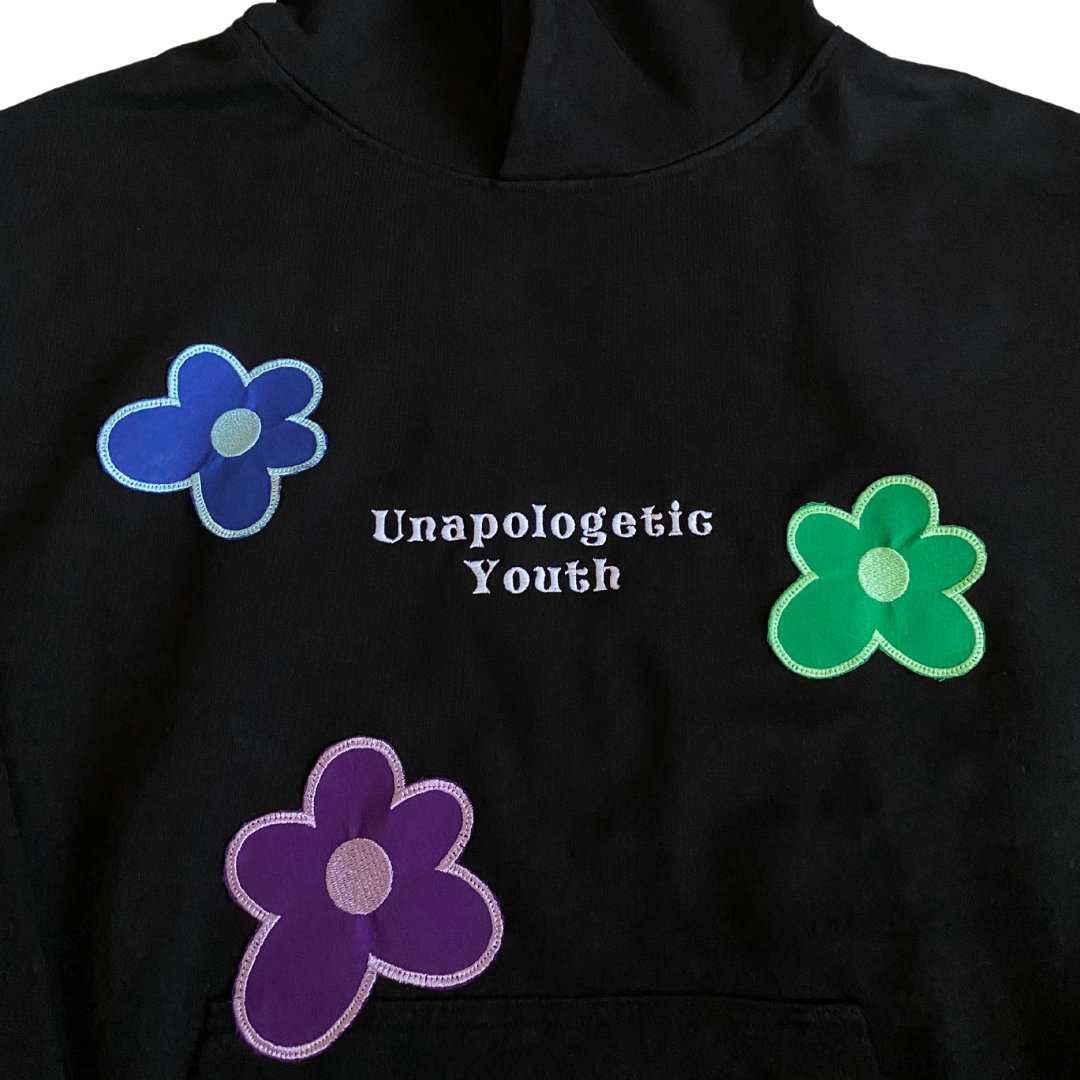 Unapologetic Youth Hippie Dreams hoodie featuring colorful, bohemian-inspired design with a relaxed fit and cozy fabric.