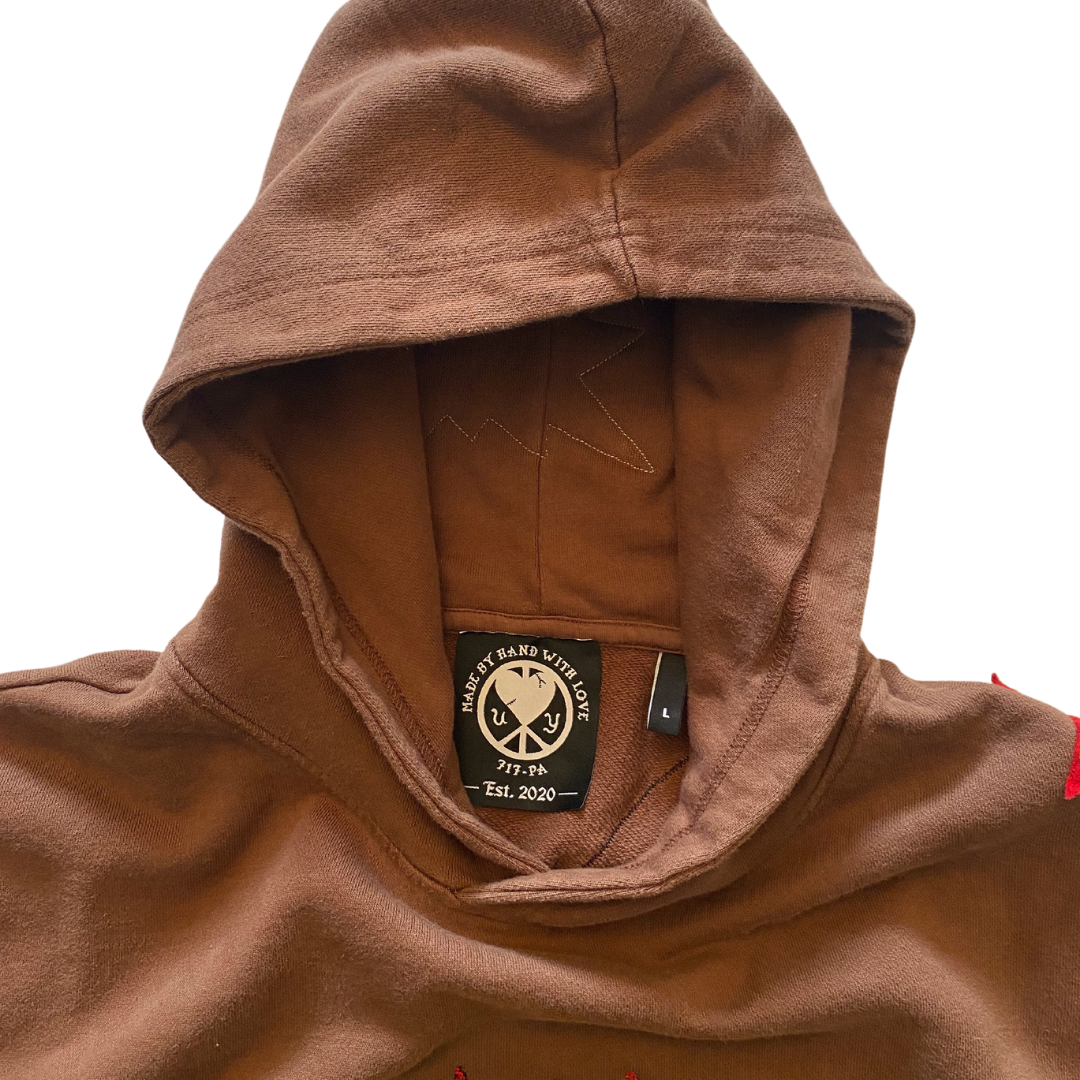 Unapologetic Youth War Torn hoodie featuring distressed graphic print, casual fit, black fabric, and front kangaroo pocket.