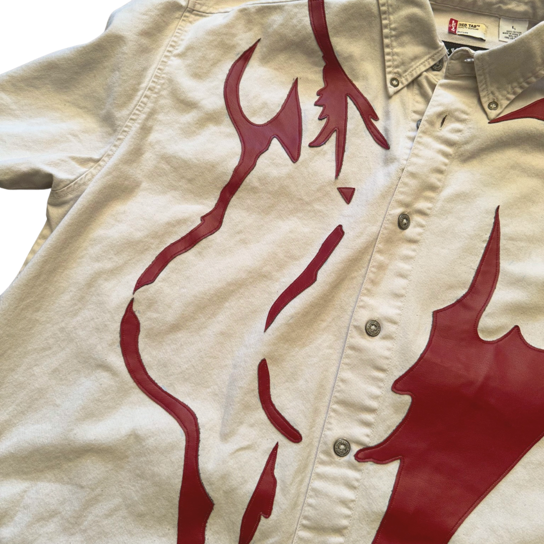Unapologetic Youth button-down shirt featuring a minimalist nudity print, displayed on a hanger against a plain background.
