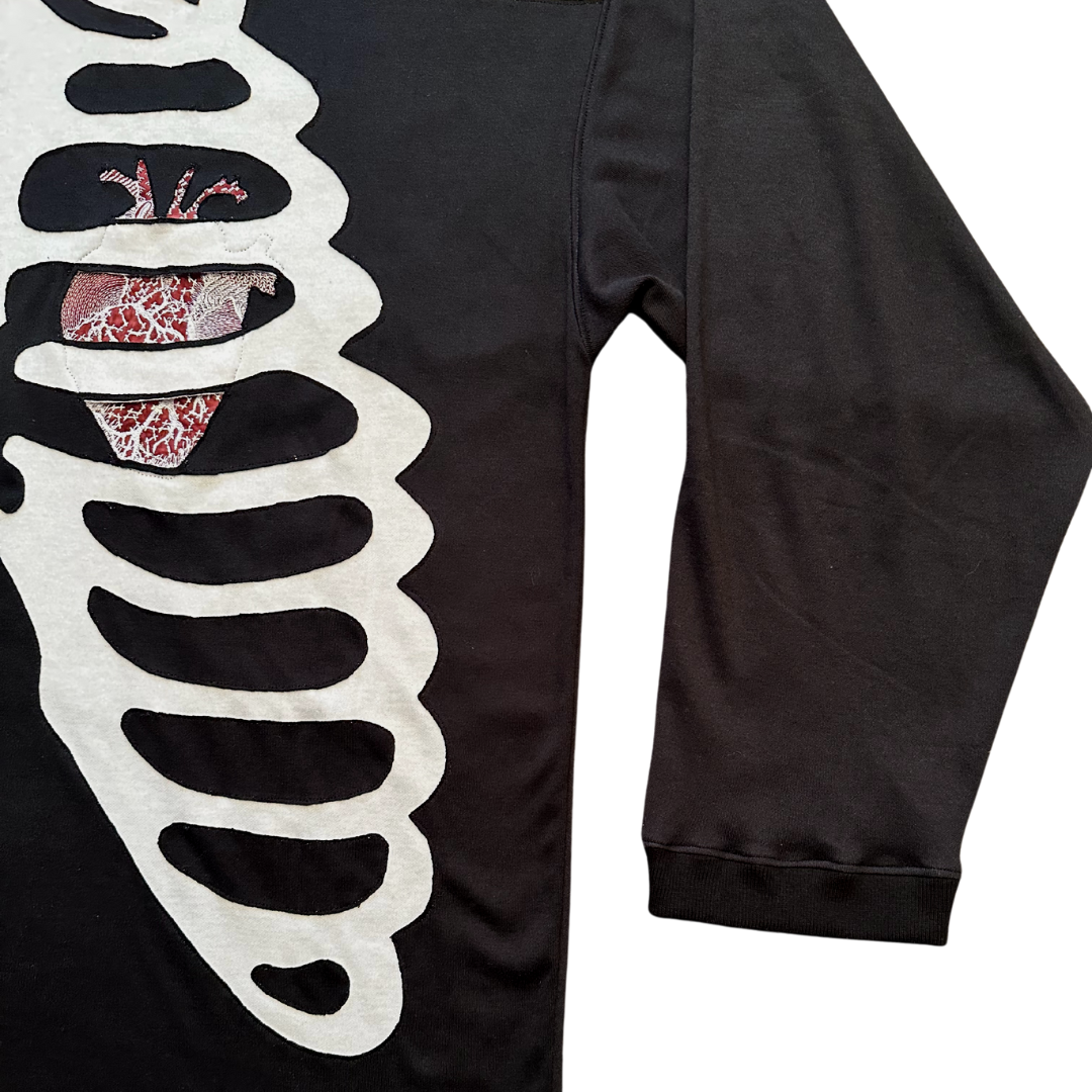 Unapologetic Youth long sleeve Bones shirt with white bone graphic on black fabric, casual streetwear style.