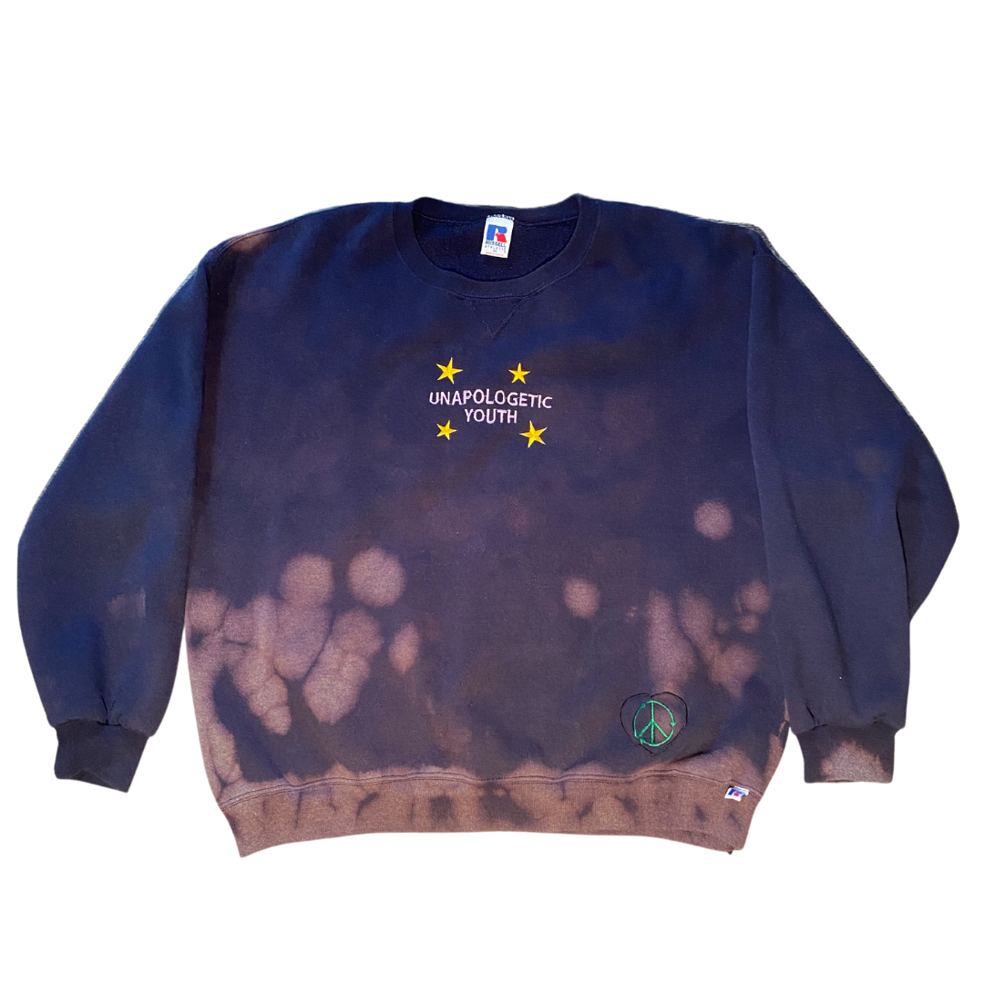 Unapologetic Youth crewneck sweater in black, featuring a comfortable fit and soft fabric, displayed on a plain background.