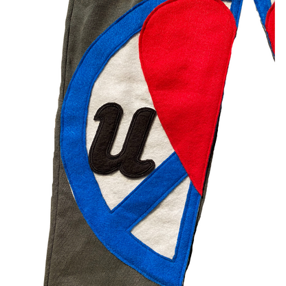 Unapologetic Youth Split Logo sweatpants in black with white logo detail, casual fleece joggers for comfortable everyday wear.