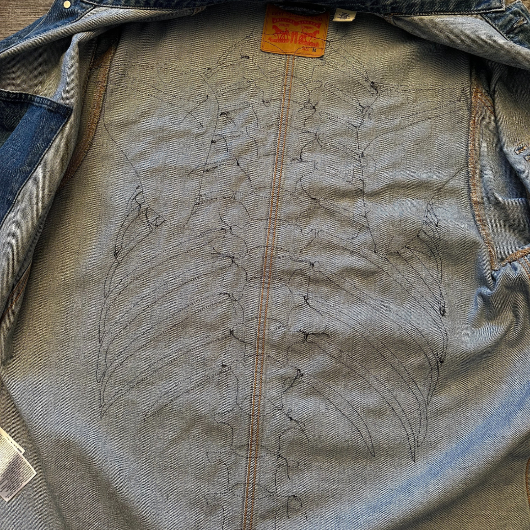 Unapologetic Youth denim jean jacket with bones design, casual fit, featuring classic collar and button closure.
