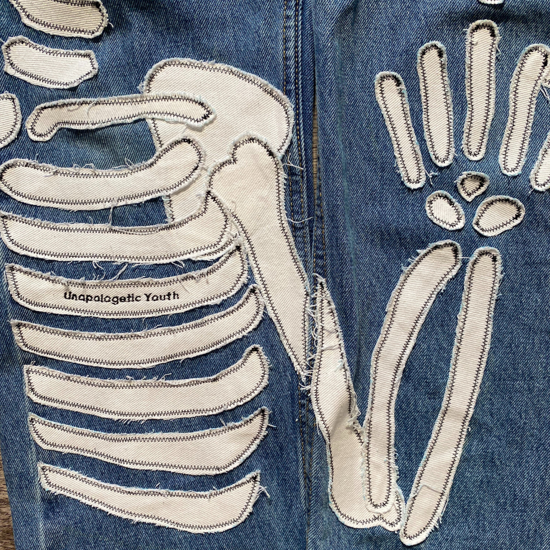 Unapologetic Youth x Levi blue denim jeans, "To The Bone" style, featuring classic fit and detailed stitching.