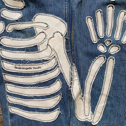 Unapologetic Youth x Levi blue denim jeans, "To The Bone" style, featuring classic fit and detailed stitching.