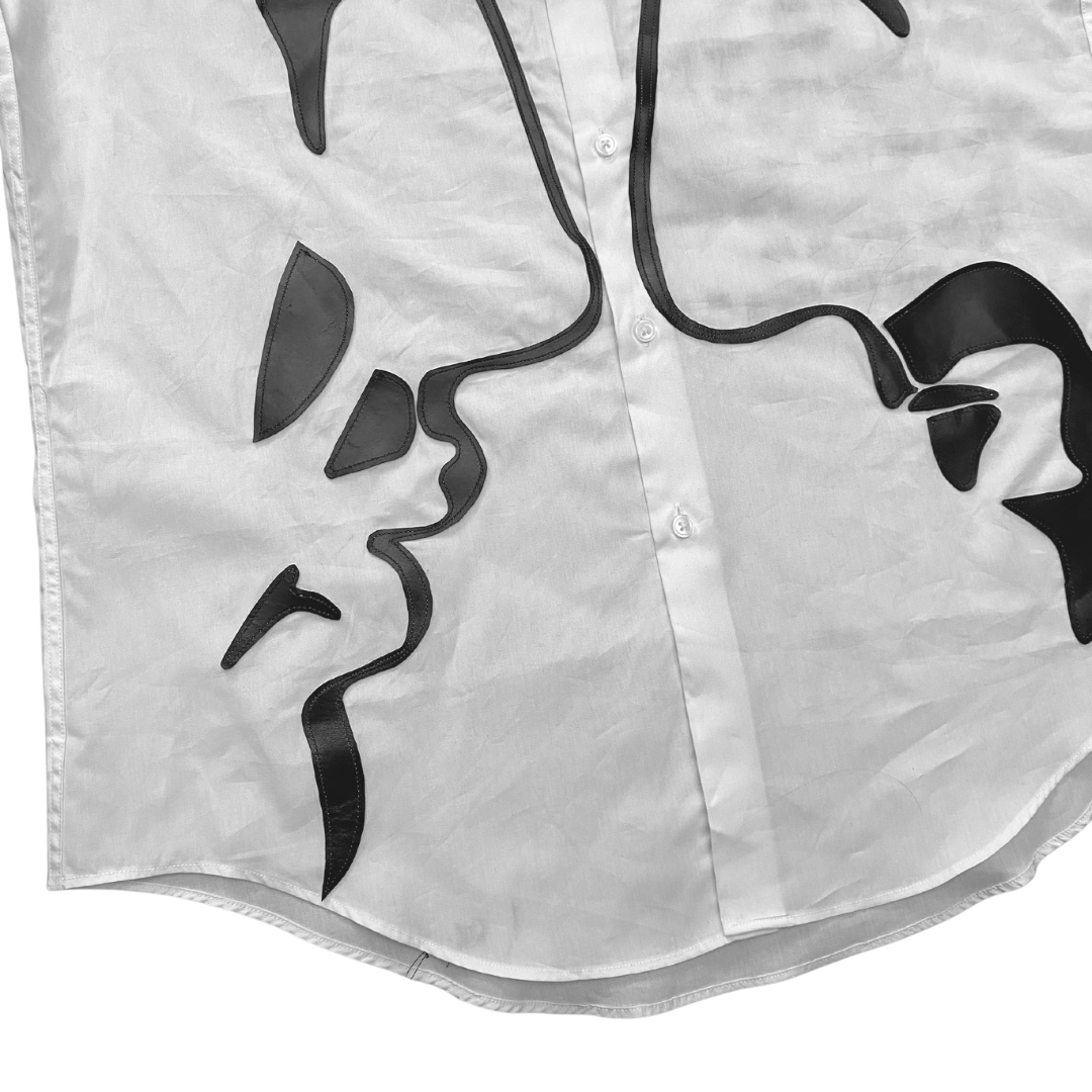 Unapologetic Youth button-down shirt featuring a vibrant face print design, displayed on a hanger against a neutral background.