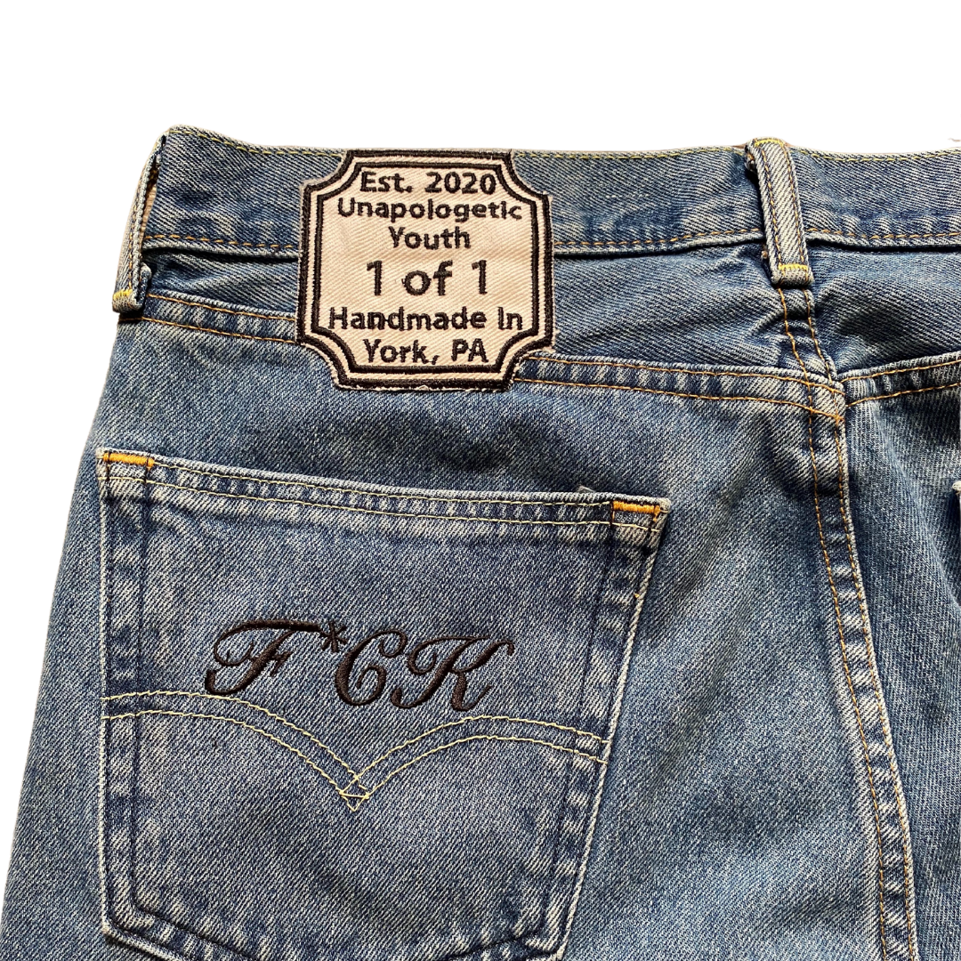 Blue denim jeans from Unapologetic Youth x Levi's "To The Bone" collection, showcasing classic fit and detailed stitching.