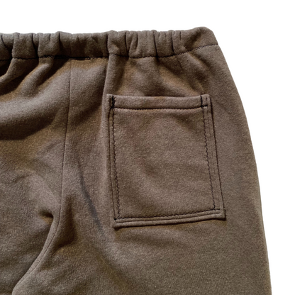 Unapologetic Youth F*cked medium sweatpants with bold logo text, relaxed fit, and soft fabric, shown in a casual setting.