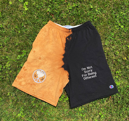 Unapologetic Youth x Champion Sunburst shorts with vibrant sunburst pattern and comfortable fit, displayed on a hanger.
