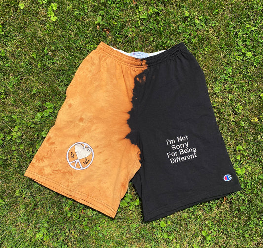 Unapologetic Youth x Champion Sunburst shorts with vibrant sunburst pattern and comfortable fit, displayed on a hanger.