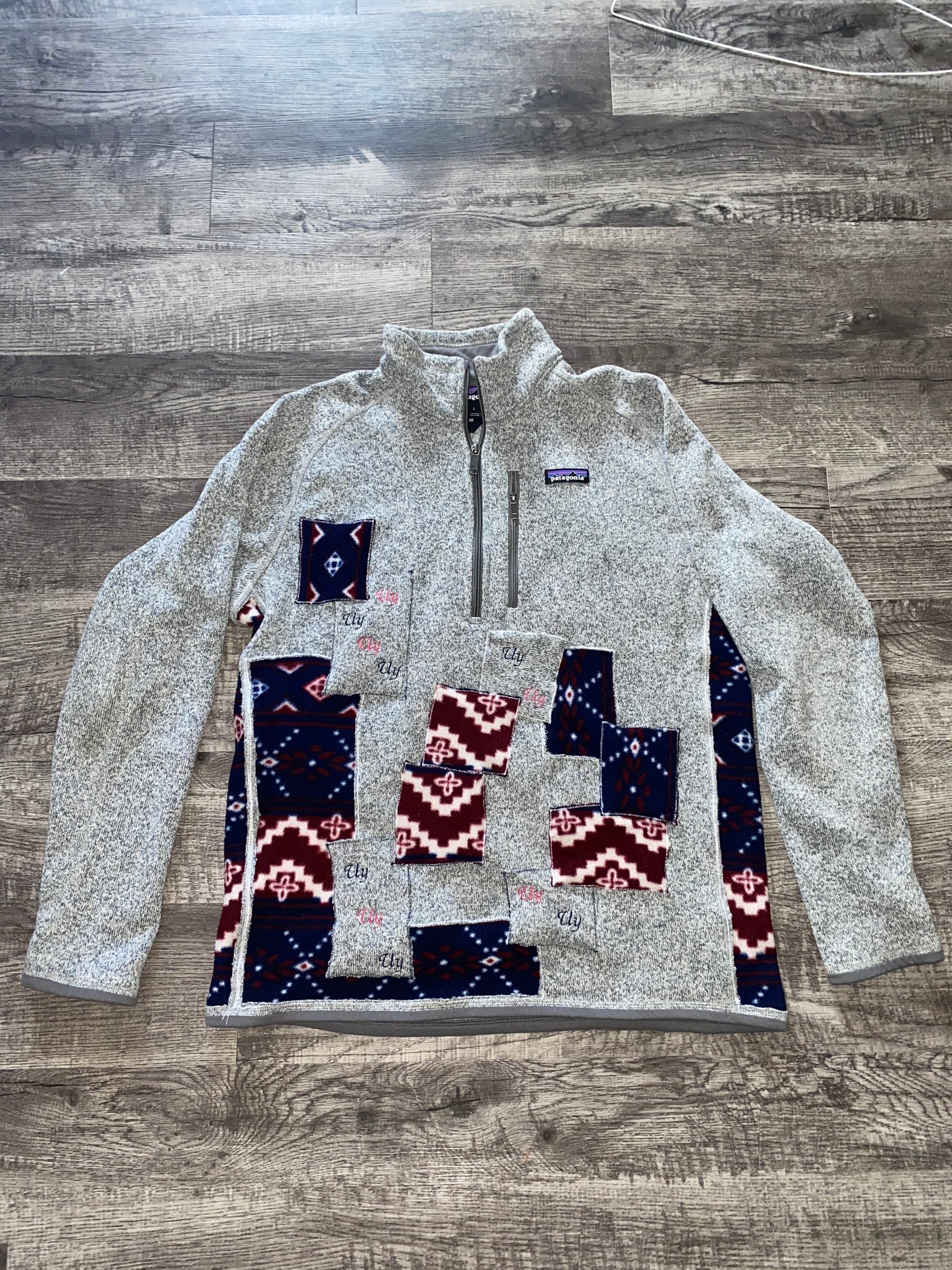 Unapologetic Youth x Patagonia fleece jacket in black, showing the front view with the brand logo and cozy fleece texture.