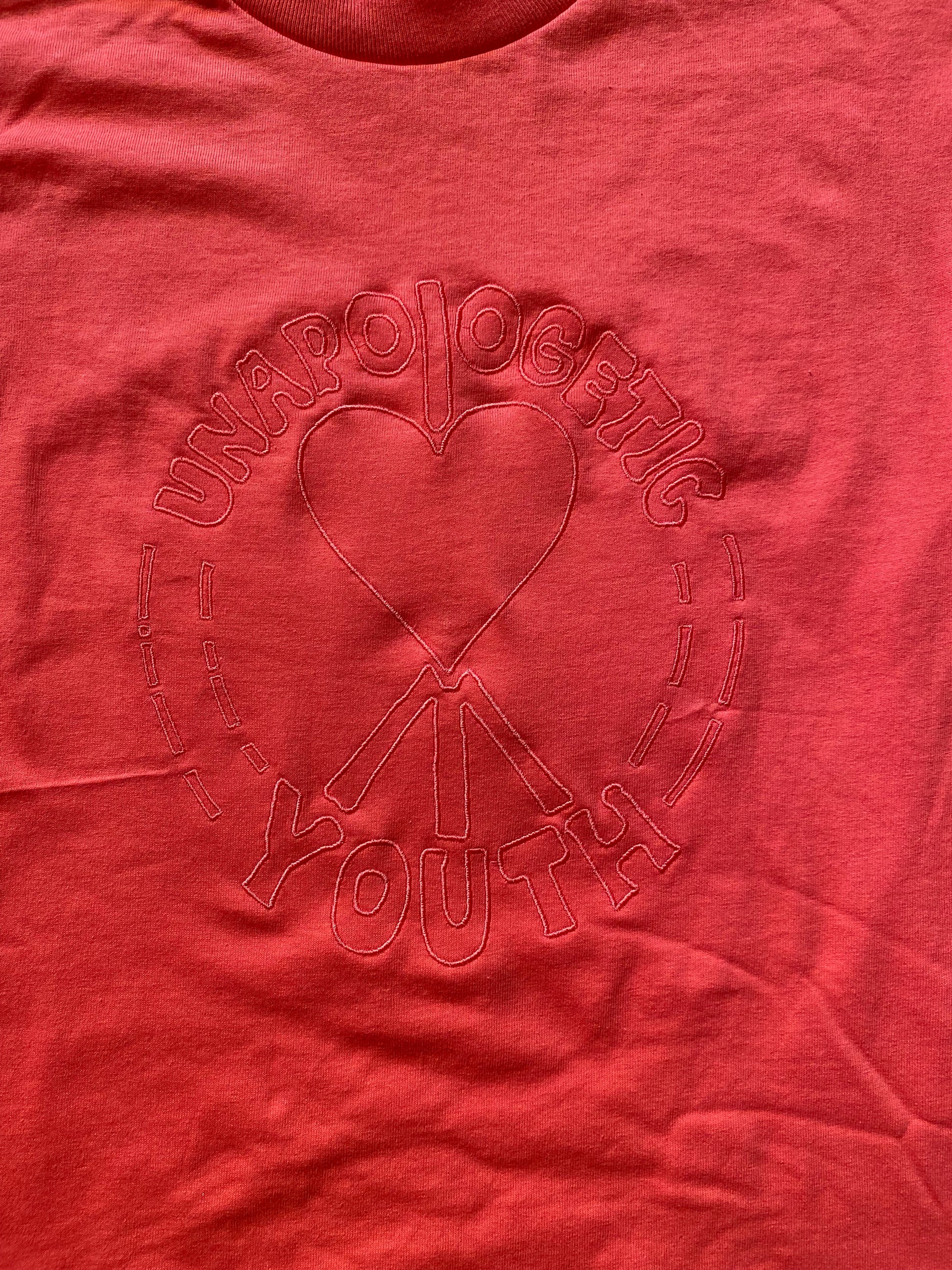 Small Unapologetic Youth T-shirt in white, featuring a comfortable fit and casual style, shown flat on a plain background.