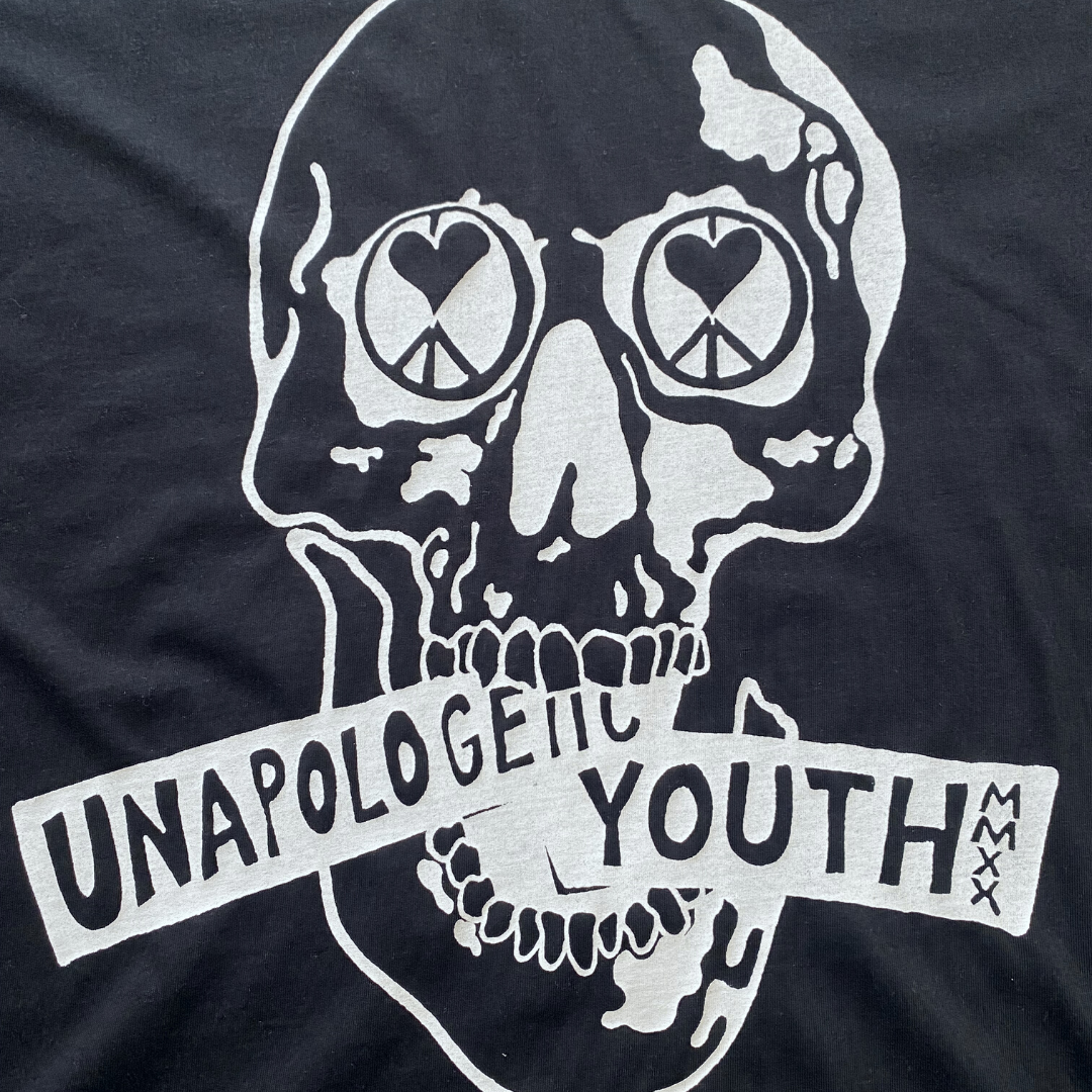 Black Essential Skelly Tee by Unapologetic Youth, casual black T-shirt featuring a bold skull graphic design.
