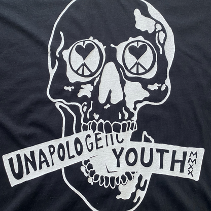 Black Essential Skelly Tee by Unapologetic Youth, casual black T-shirt featuring a bold skull graphic design.