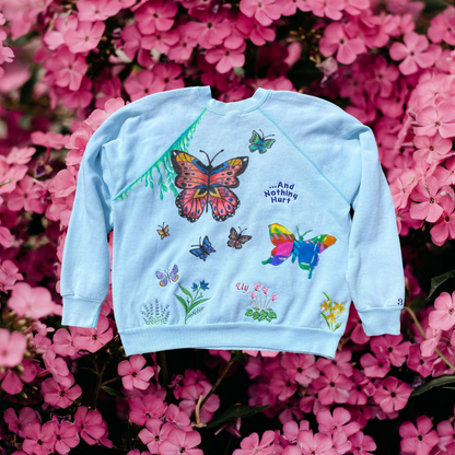 Unapologetic Youth Flower Child crewneck sweatshirt featuring a vibrant floral design on soft fabric.