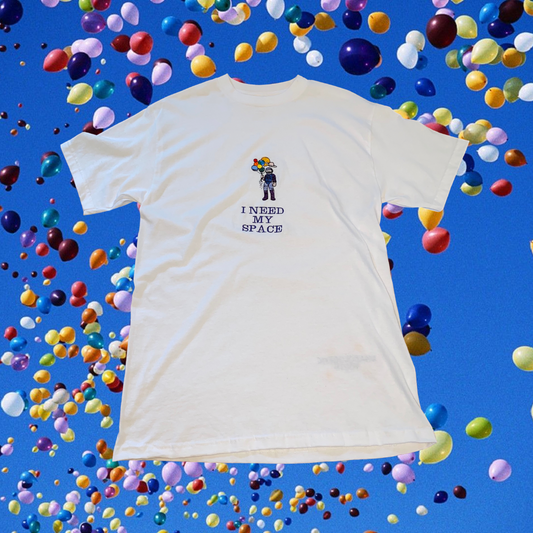 Unapologetic Youth Spaceman T-shirt featuring a cosmic astronaut design on a black cotton tee.