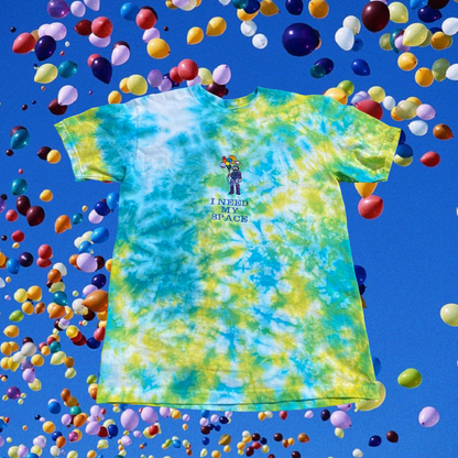 Unapologetic Youth Spaceman Cosmos T-Shirt featuring a cosmic space design with a spaceman illustration on a black background.