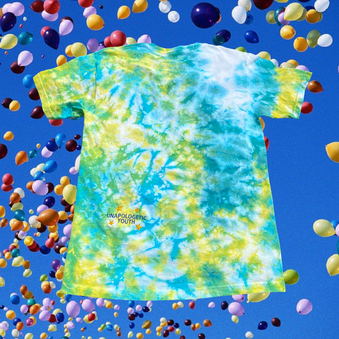 Unapologetic Youth Spaceman Cosmos T-Shirt featuring a space-themed design with a cosmic scene and a spaceman illustration.