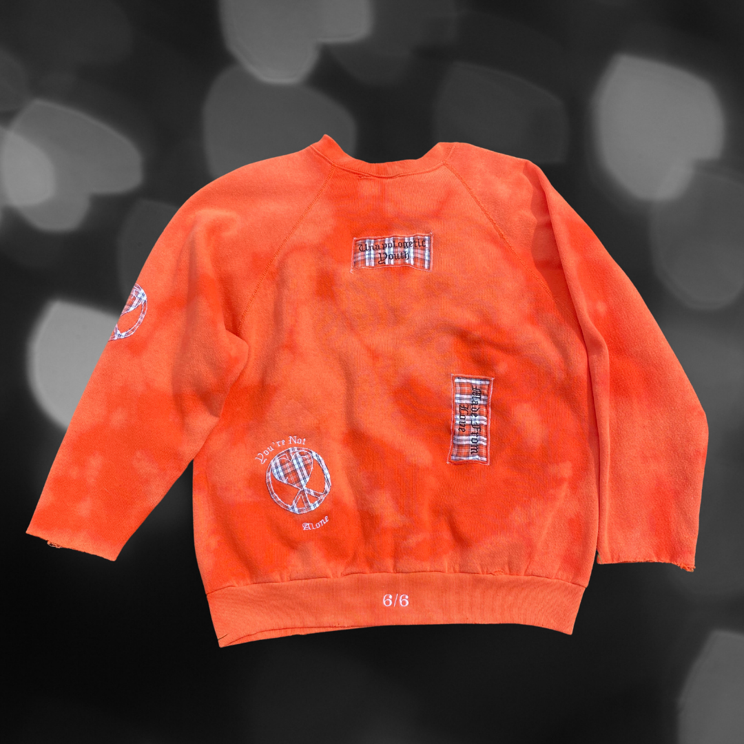 Unapologetic Youth crewneck sweatshirt featuring the "Love" graphic in black text on a comfortable white fabric.