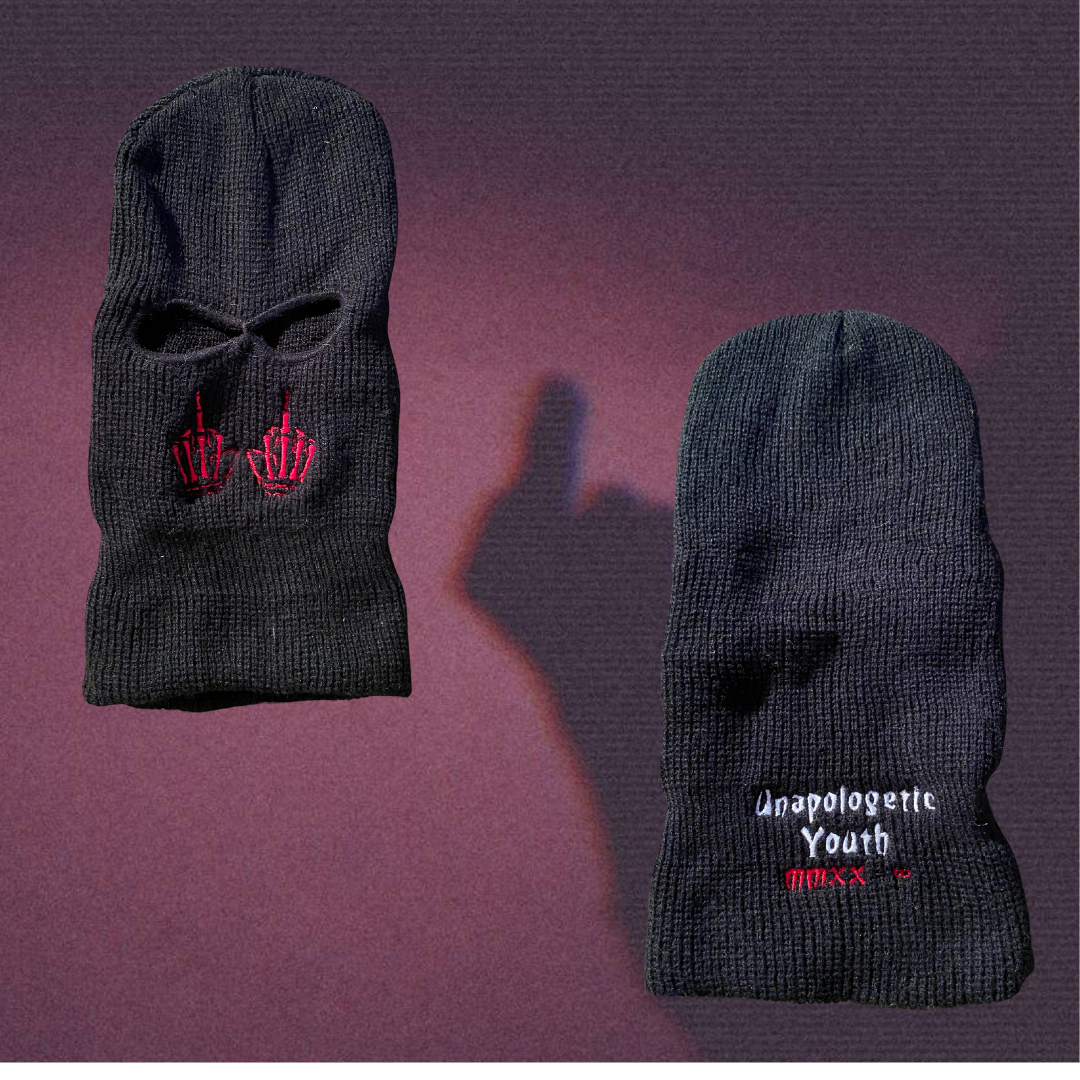 Unapologetic Youth Lick Hitters ski mask with bold graphic design, featuring a black fabric covering the head and face.