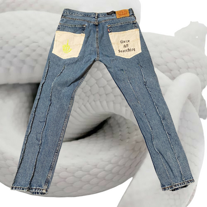 Unapologetic Youth Abstraction jeans featuring abstract design, denim fabric, and modern fit, displayed on a hanger.